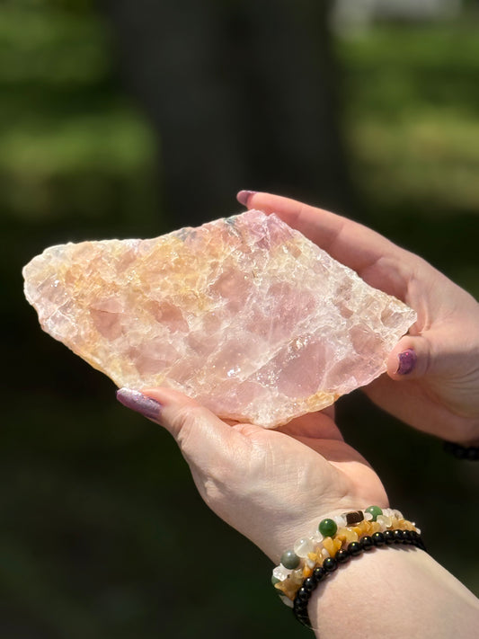Front view of polished Rose Quartz with Golden Healer slab, displaying soft pink tones and radiant golden veining in natural daylight.