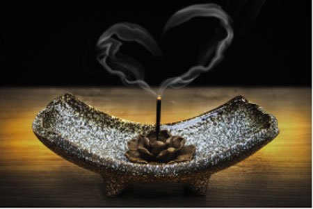 Incense Being Burned with the smoke in the shape of a heart