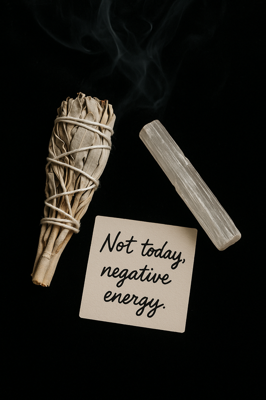 Ethically sourced white sage bundle and selenite crystal next to a card reading “Not today, negative energy” on a black background—spiritual smoke cleansing ritual setup.