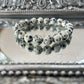 Handmade Dalmatian Jasper bracelet featuring natural spotted beads displayed on a mirrored silver tray, symbolizing grounding and joyful energy for chakra healing
