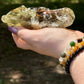 Raw-style smoky citrine crystal showing its deep amber core and layered structure, captured in bright daylight to highlight its sparkle and depth.