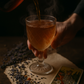 A steaming glass of lavender peach herbal tea being poured beside dried herbs and The Empress tarot card, styled for The High Lady blend inspired by ACOTAR